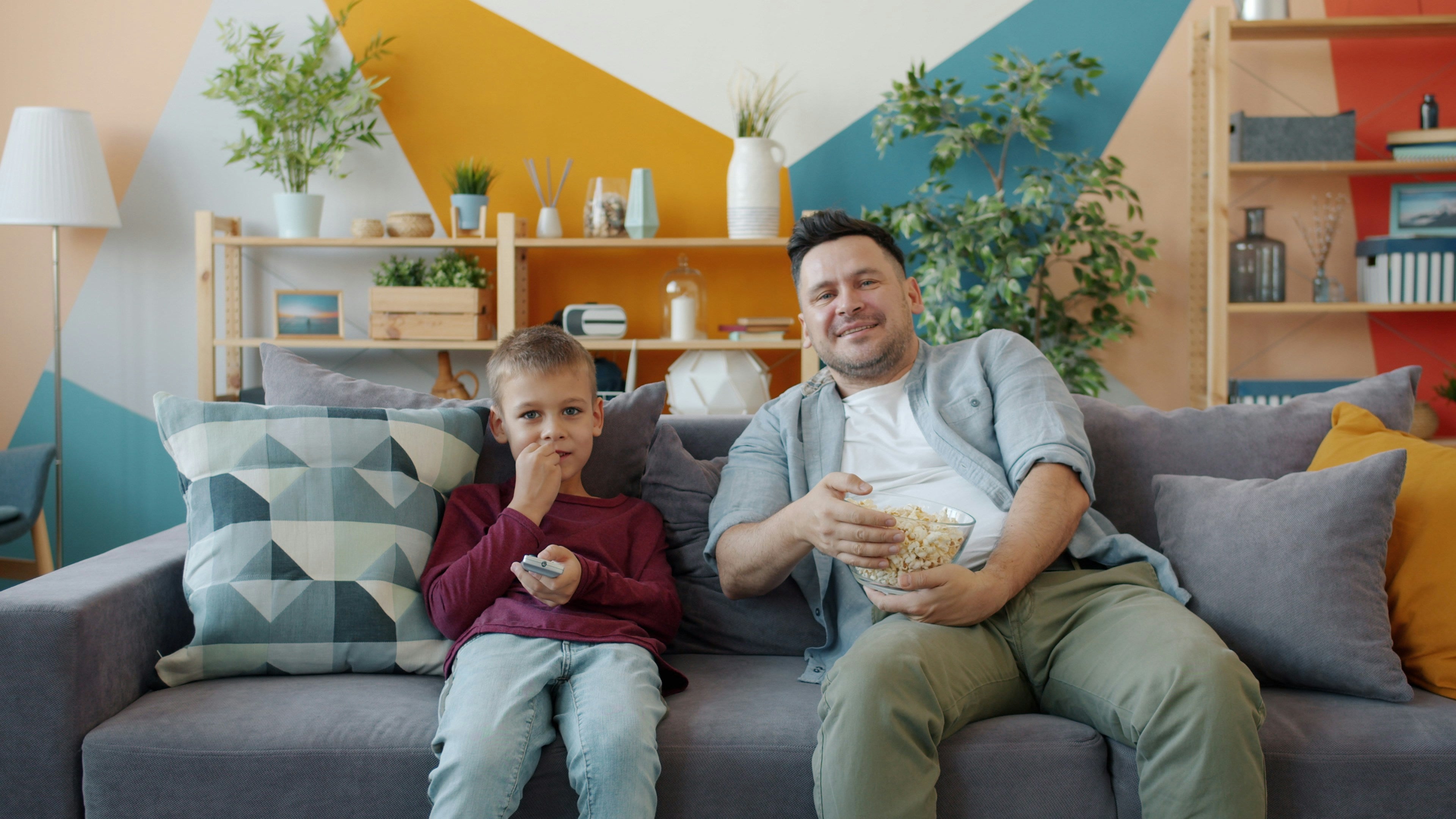 A family watching television together on the sofa